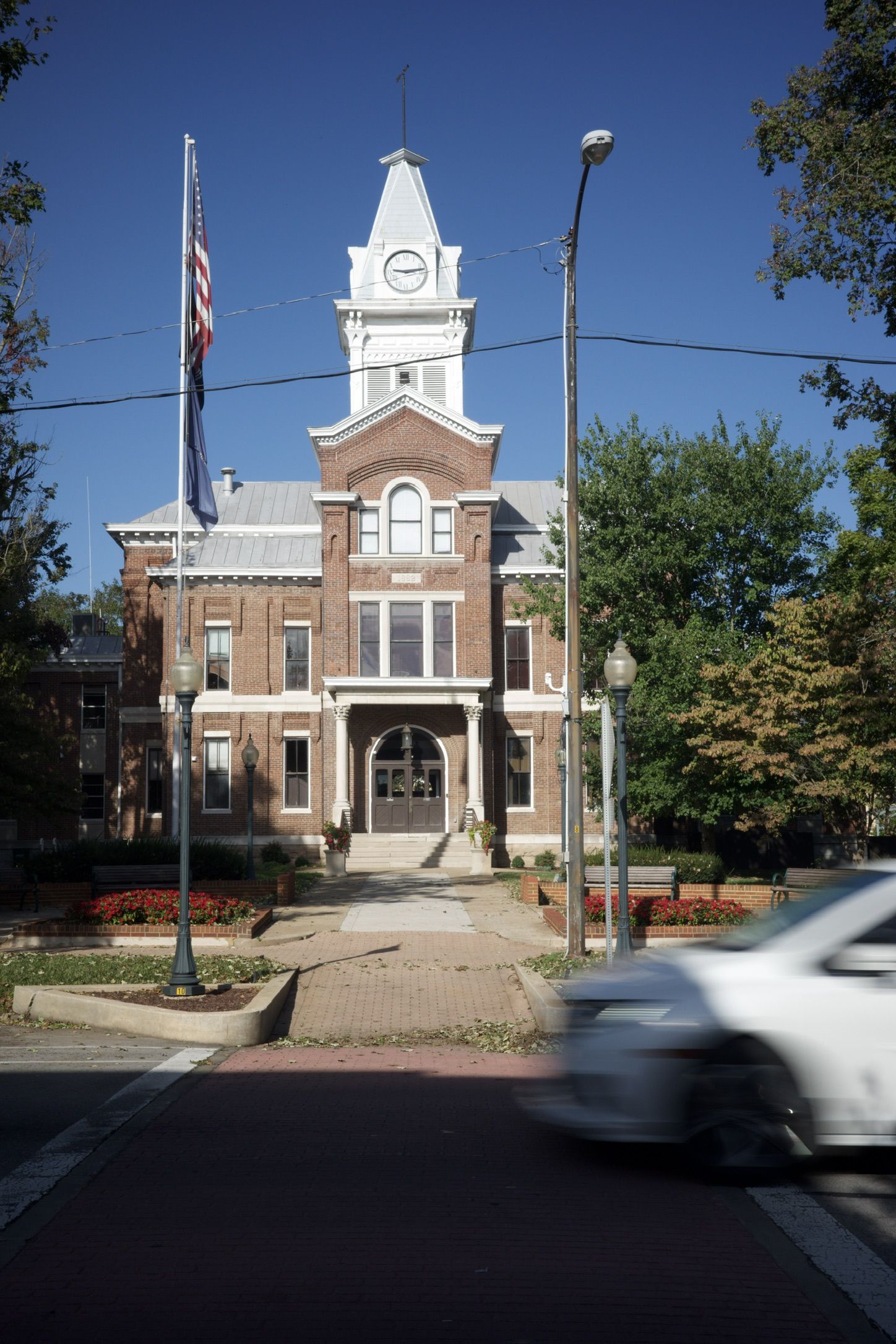 A historic brick Kentucky county courthouse with a white clock tower